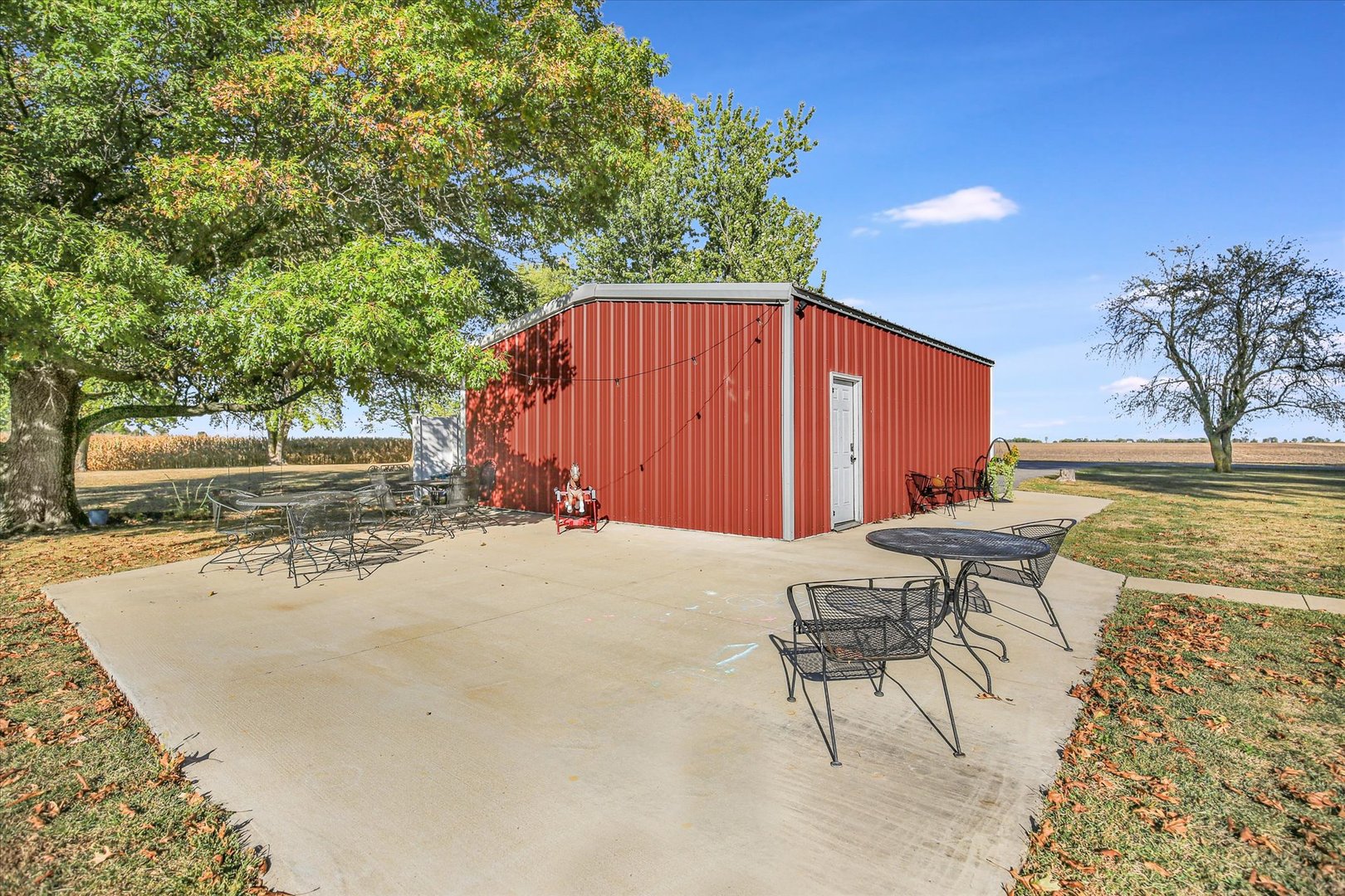 151 County 1700 Road East Villa Grove, IL 61956 - Photo 14 of 76 a view of a patio with a table and chairs and potted plants