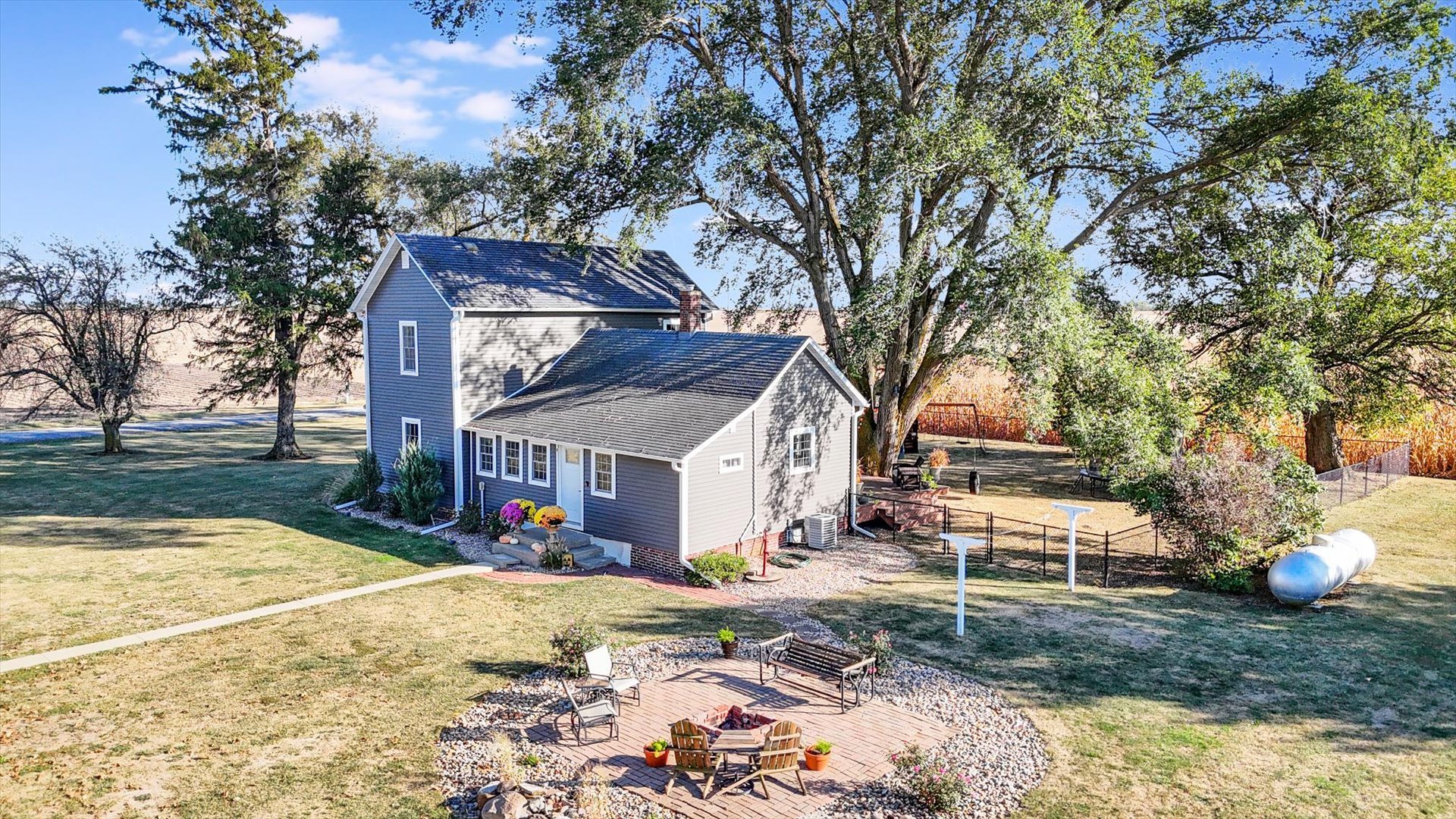151 County 1700 Road East Villa Grove, IL 61956 - Photo 18 of 76 a view of a white house with a yard and large tree