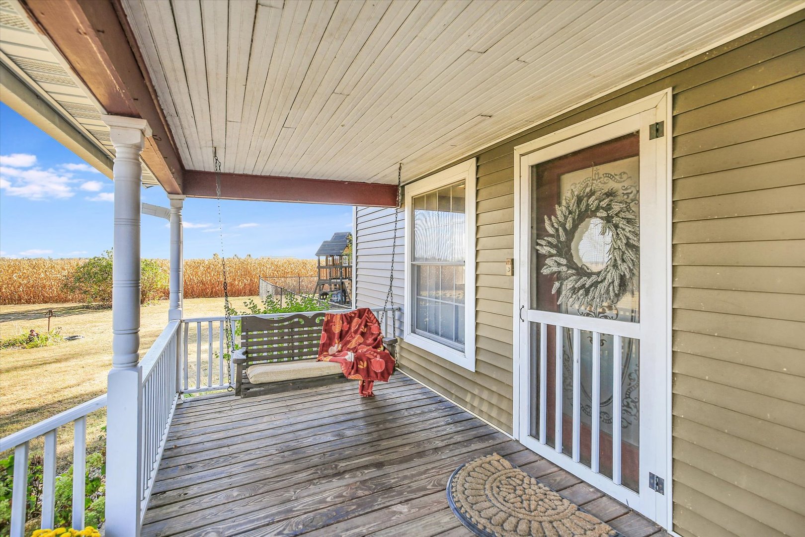 151 County 1700 Road East Villa Grove, IL 61956 - Photo 30 of 76 a balcony with wooden floor table and chairs