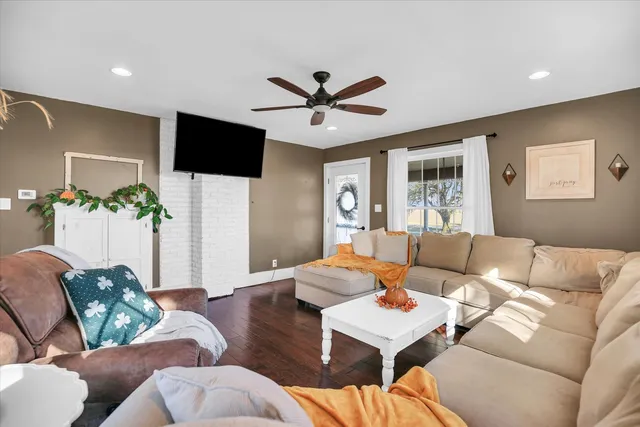 a spacious bedroom with a bed and a chandelier