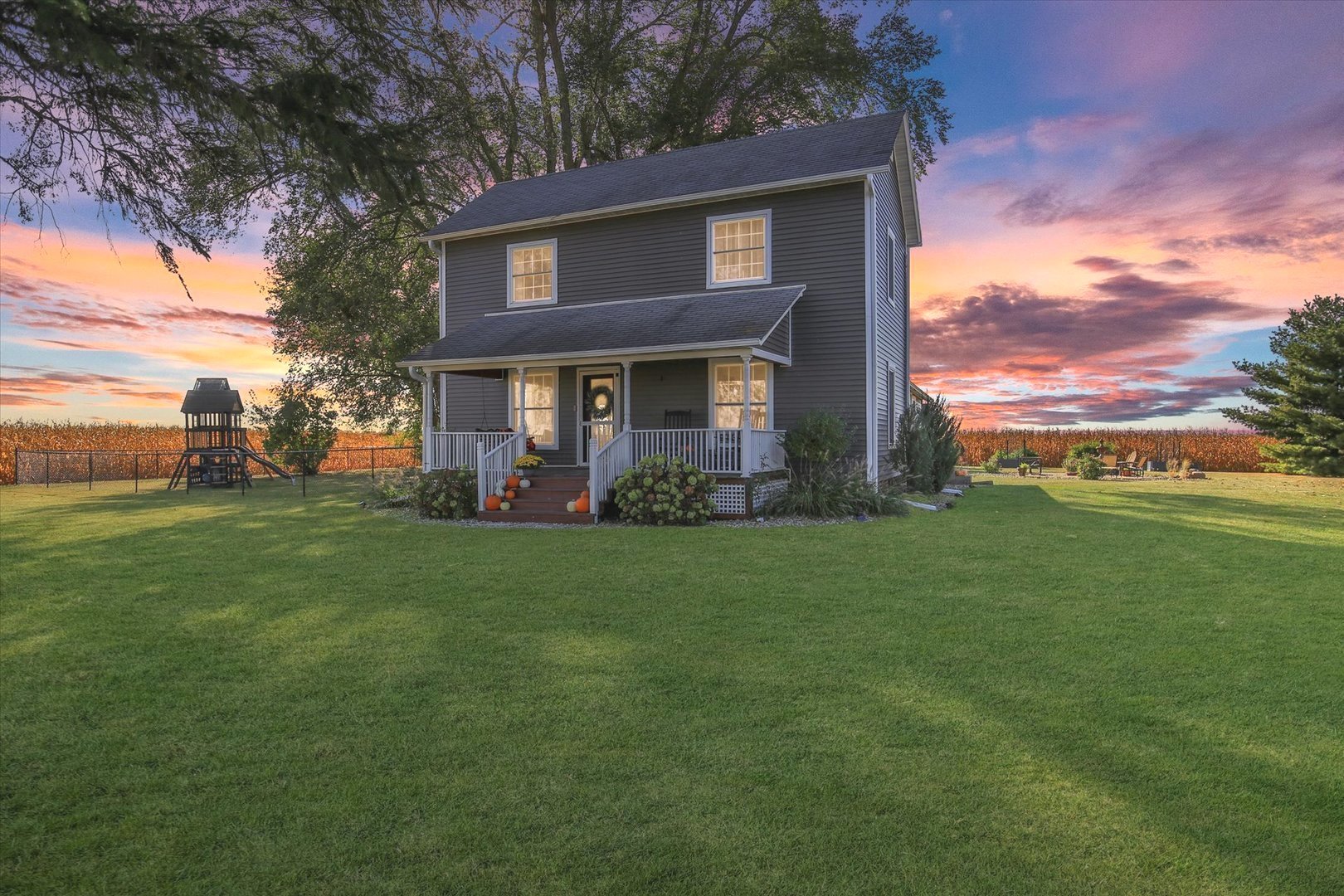 151 County 1700 Road East Villa Grove, IL 61956 - Photo 4 of 76 a view of a house with a big yard potted plants and large tree