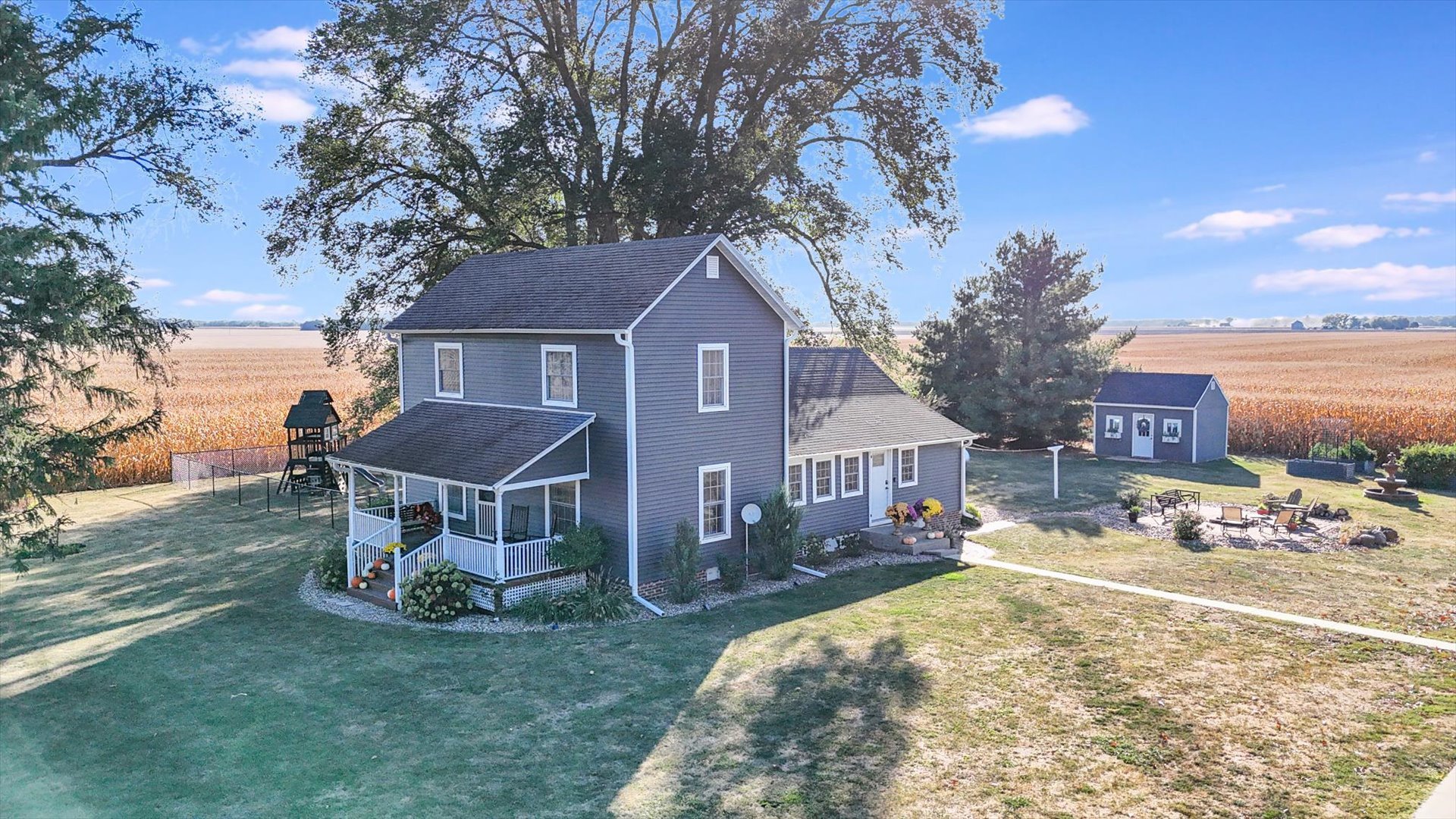 151 County 1700 Road East Villa Grove, IL 61956 - Photo 10 of 76 a view of a house with a yard patio and fire pit