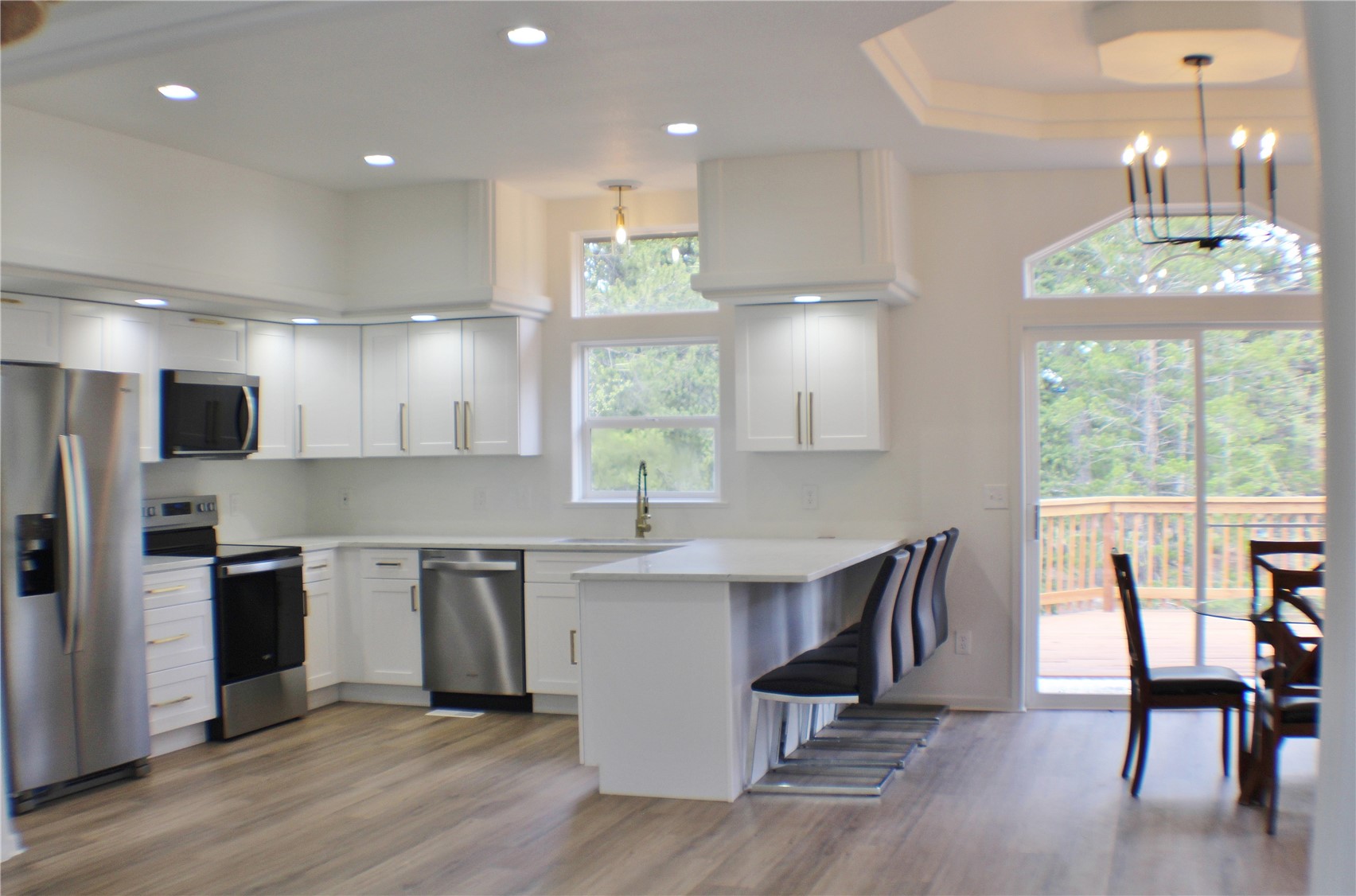 2095 Mullenville Road Fairplay, CO 80440 - Photo 4 of 22 a kitchen with stainless steel appliances a dining table chairs stove refrigerator and cabinets