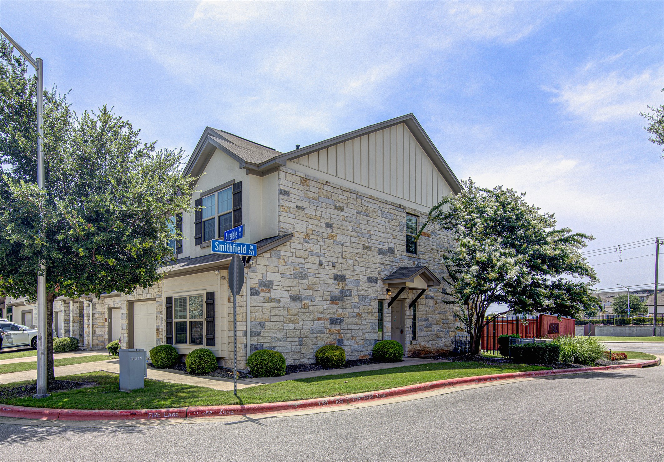 1407 Airedale Road, Unit 1104 Austin, TX 78748 - Photo 3 of 26 A corner residence presents a tasteful blend of stone and siding, complemented by established landscaping.