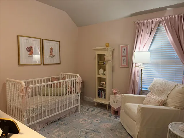 a bedroom with a bed and a lamp