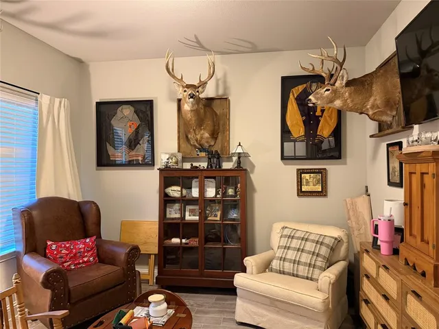 a living room with furniture cabinets and a flat screen tv