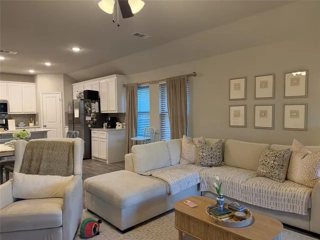 a kitchen with a refrigerator a stove a sink and a microwave