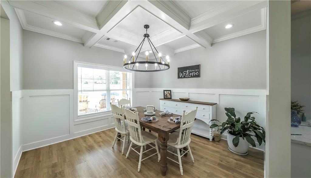 2392 Welcome Road Roopville, GA 30170 - Photo 16 of 65 a view of a dining room with furniture wooden floor and chandelier