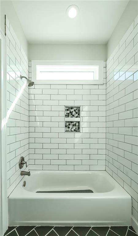 2392 Welcome Road Roopville, GA 30170 - Photo 19 of 65 a bathroom with a bathtub and a shower