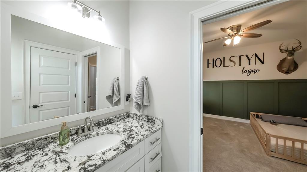 2392 Welcome Road Roopville, GA 30170 - Photo 21 of 65 a bathroom with a sink and a mirror