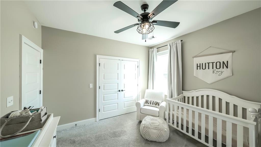 2392 Welcome Road Roopville, GA 30170 - Photo 23 of 65 a bedroom with furniture and a chandelier