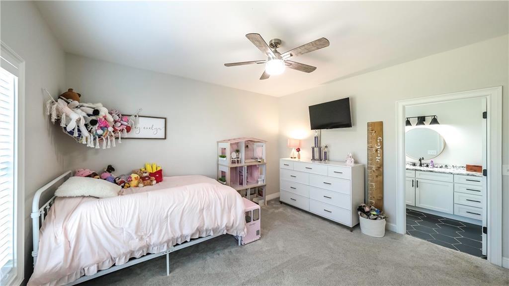 2392 Welcome Road Roopville, GA 30170 - Photo 32 of 65 a bedroom with a bed and a chandelier