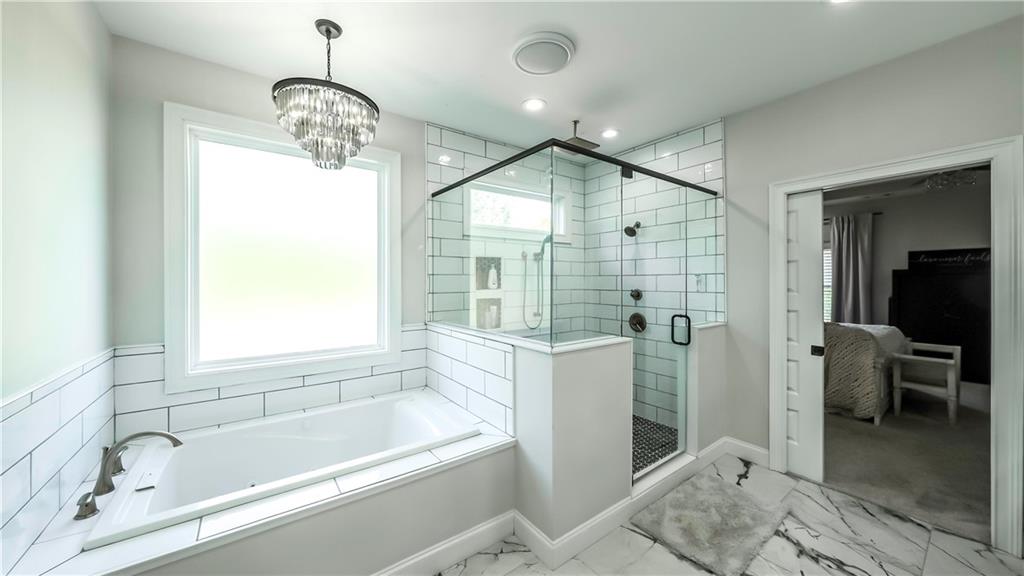 2392 Welcome Road Roopville, GA 30170 - Photo 54 of 65 a bathroom with a bathtub and a shower