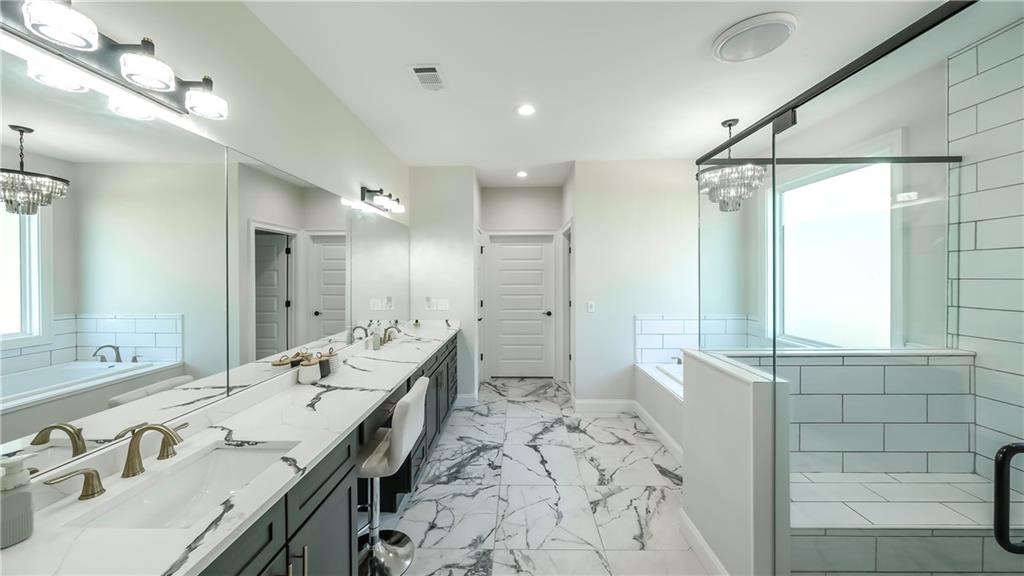 2392 Welcome Road Roopville, GA 30170 - Photo 56 of 65 a spacious bathroom with a double vanity sink mirror and shower