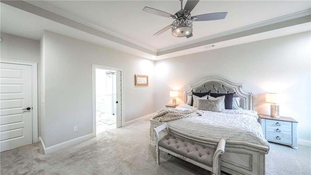 2392 Welcome Road Roopville, GA 30170 - Photo 59 of 65 a bedroom with a bed and a chandelier