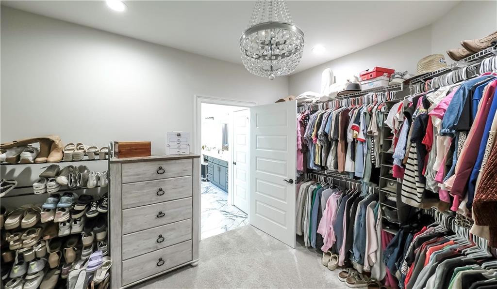 2392 Welcome Road Roopville, GA 30170 - Photo 64 of 65 a view of walk in closet with clothes