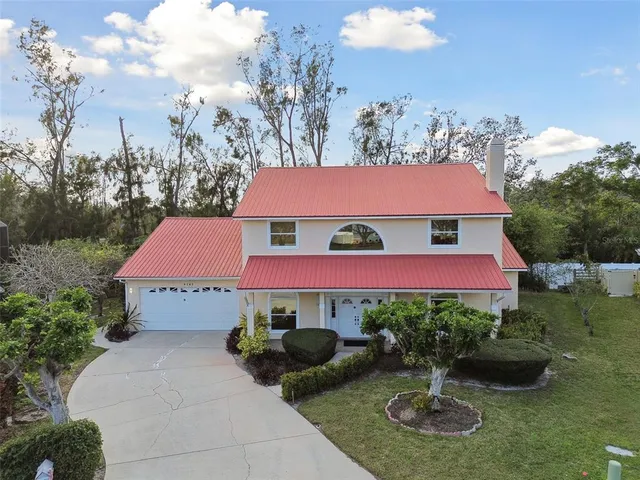 a aerial view of a house with table and chairs