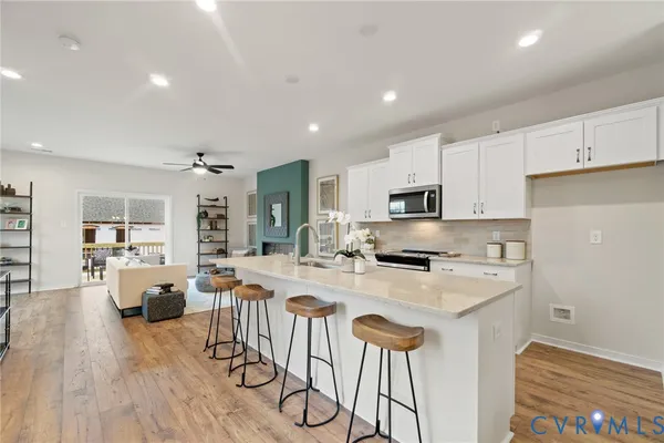 a large kitchen with a table and chairs in it