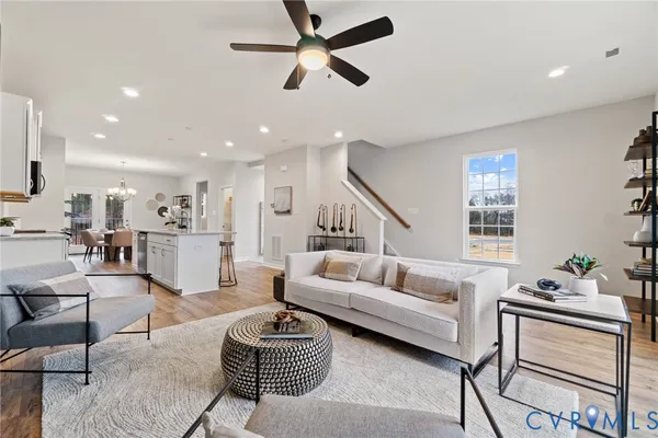 a living room with furniture ceiling fan and a rug
