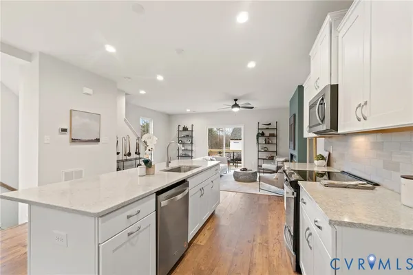 a kitchen with sink stove and cabinets