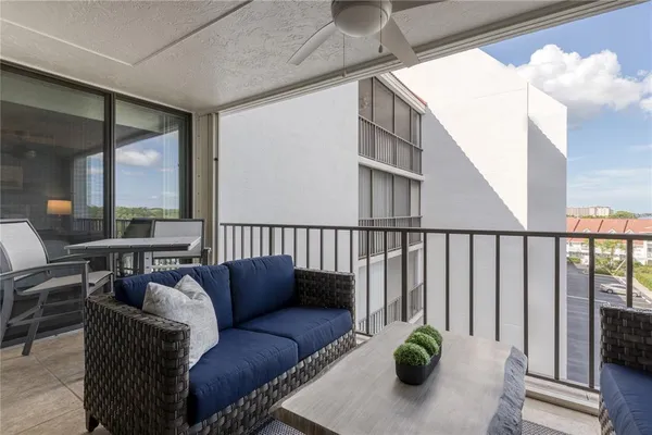 a balcony with furniture and a potted plant