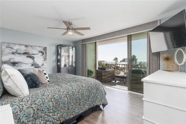 a bedroom with a large bed and a large window