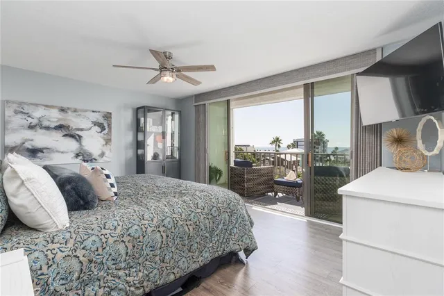 a bedroom with a large bed and a large window