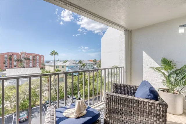 a view of a balcony with chair and potted plant