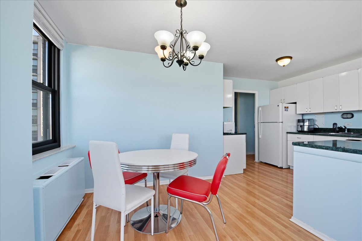 5701 North Sheridan Road, Unit 26B Chicago, IL 60660 - Photo 5 of 18 a view of a dining room with furniture and wooden floor
