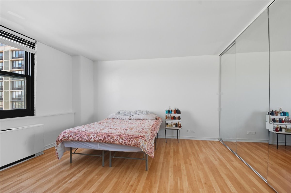5701 North Sheridan Road, Unit 26B Chicago, IL 60660 - Photo 10 of 18 a bedroom with a bed and a table