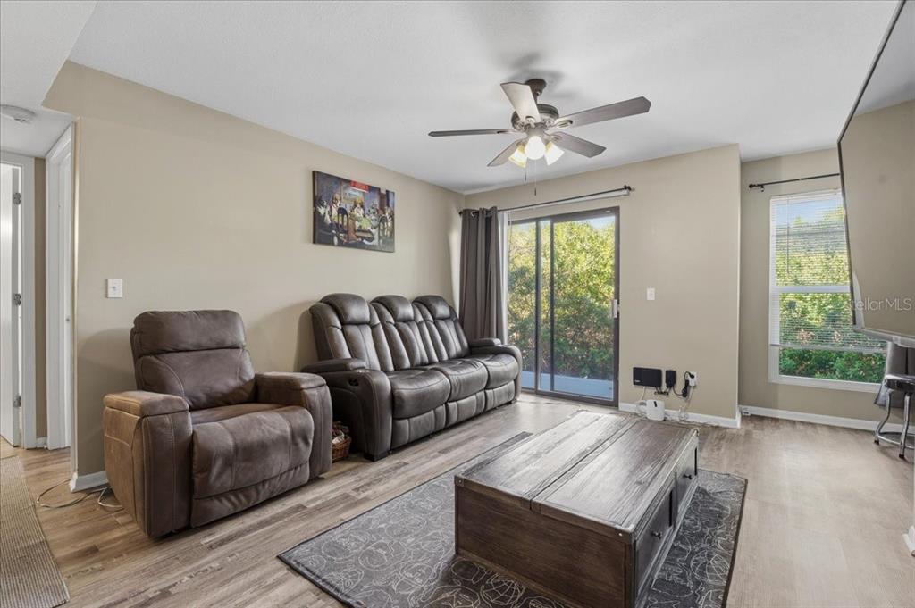 455 Alt 19, Unit 151 Palm Harbor, FL 34683 - Photo 13 of 52 a living room with furniture and a large window