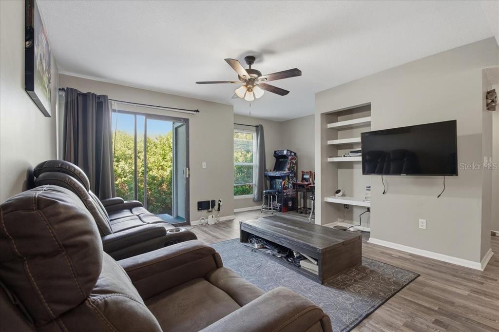 455 Alt 19, Unit 151 Palm Harbor, FL 34683 - Photo 14 of 52 a living room with furniture and a flat screen tv