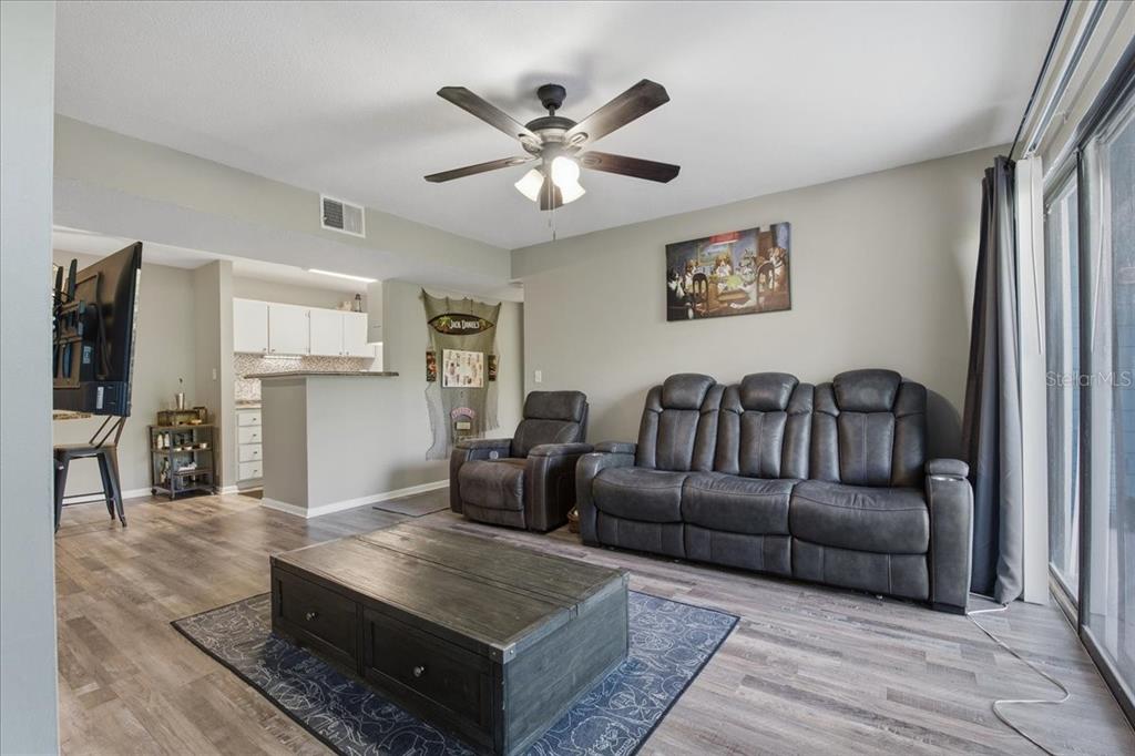455 Alt 19, Unit 151 Palm Harbor, FL 34683 - Photo 16 of 52 a living room with furniture and a flat screen tv