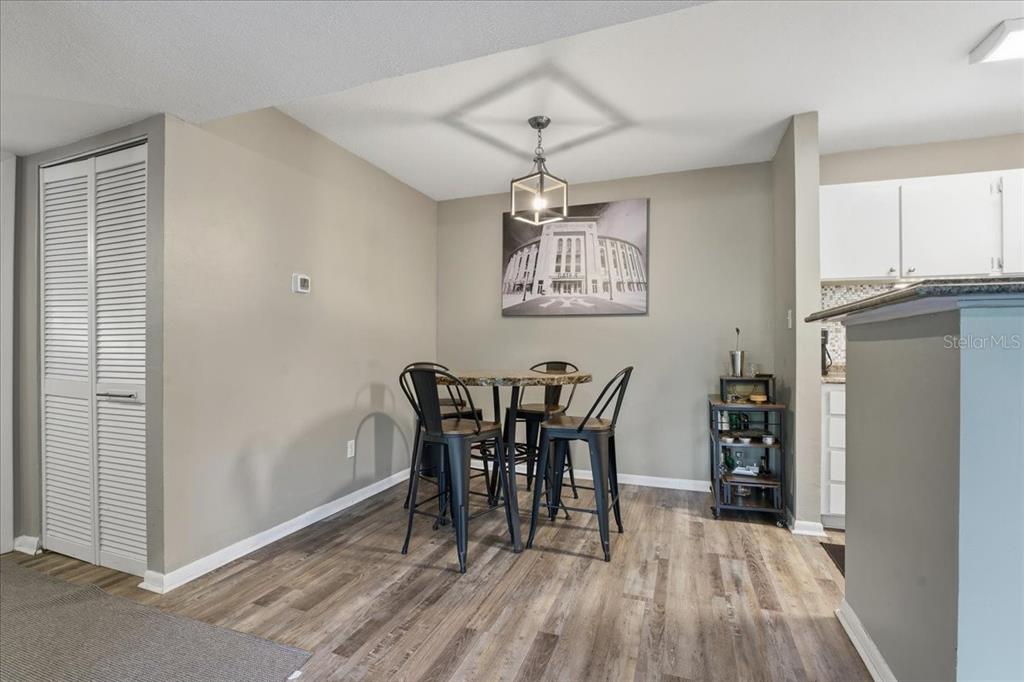 455 Alt 19, Unit 151 Palm Harbor, FL 34683 - Photo 17 of 52 a view of a dining room with furniture and wooden floor
