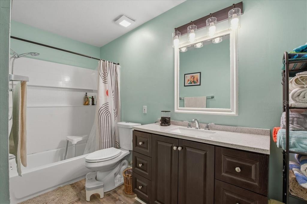 455 Alt 19, Unit 151 Palm Harbor, FL 34683 - Photo 30 of 52 a bathroom with a sink toilet vanity and shower