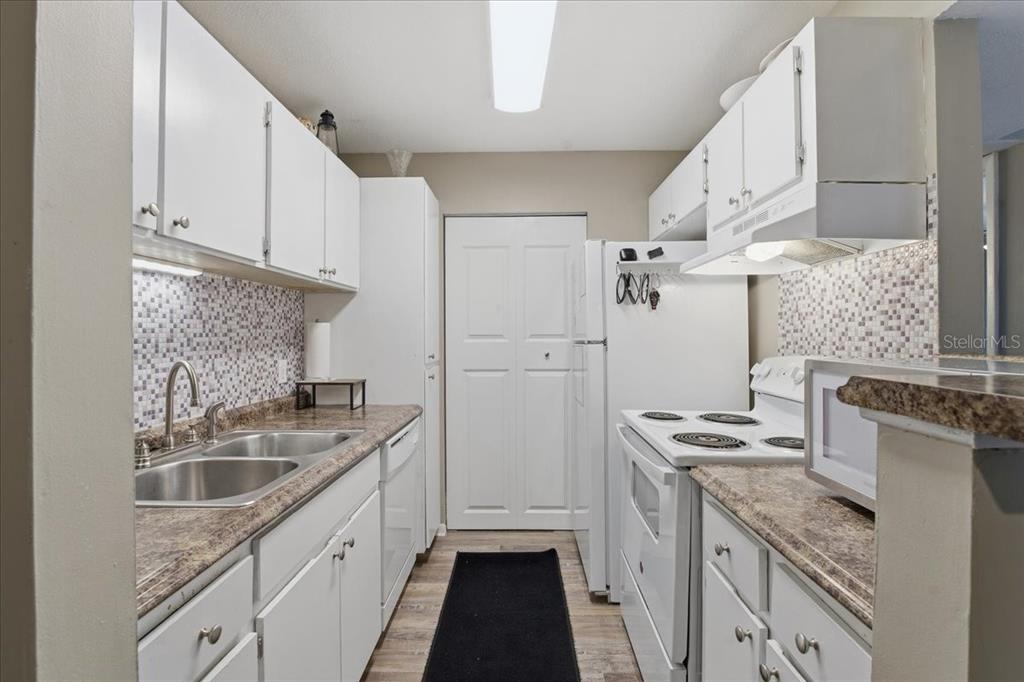 455 Alt 19, Unit 151 Palm Harbor, FL 34683 - Photo 5 of 52 a kitchen with stainless steel appliances granite countertop a sink stove and refrigerator