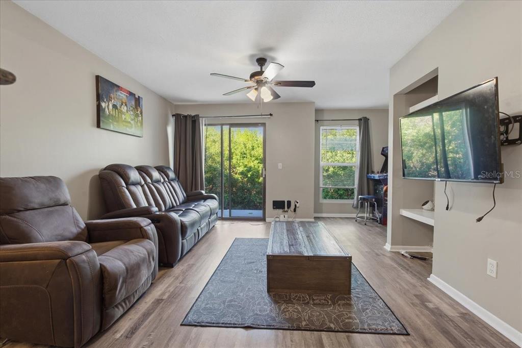 455 Alt 19, Unit 151 Palm Harbor, FL 34683 - Photo 6 of 52 a living room with furniture and a large window