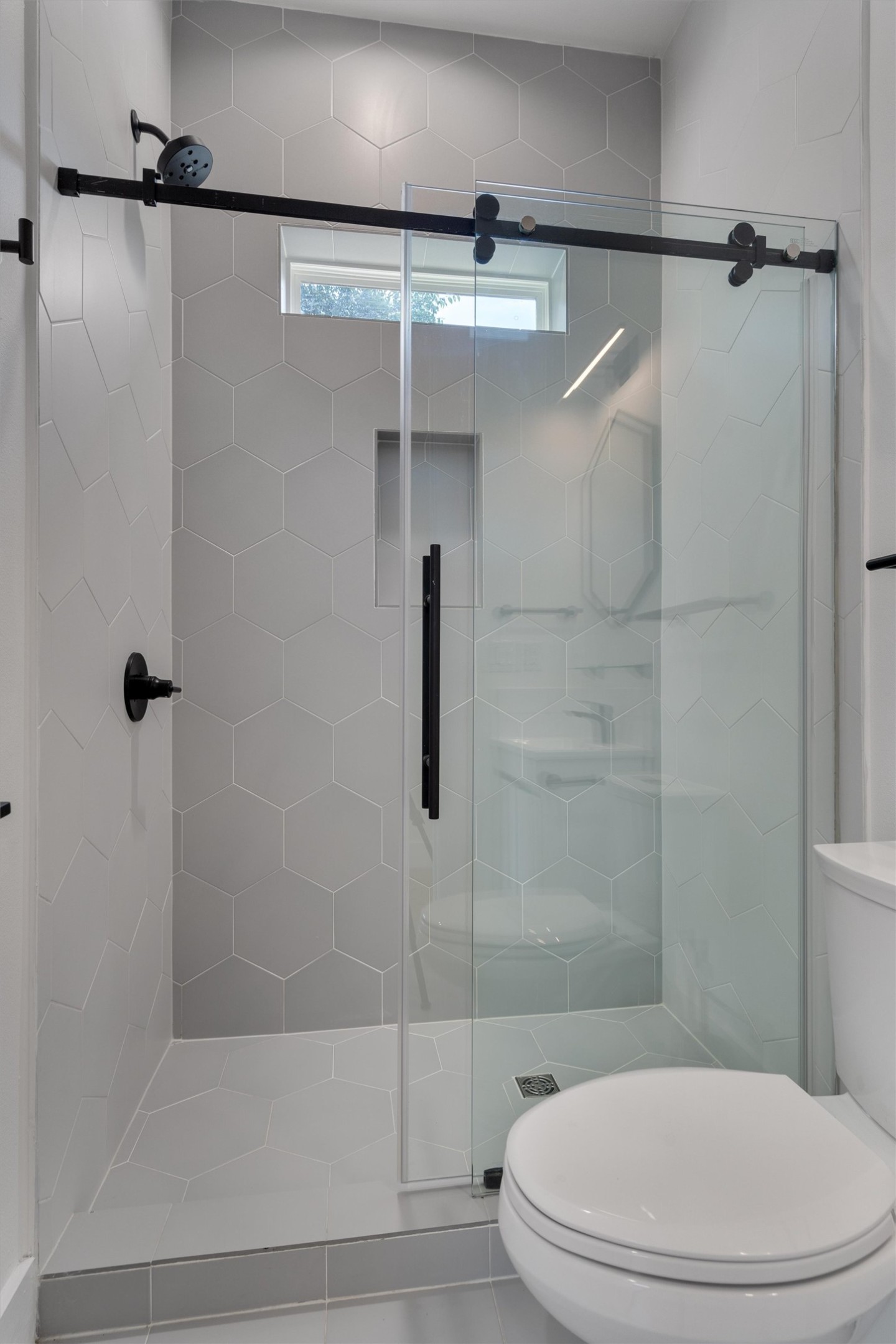 4712 Reyes Street, Unit 1 Austin, TX 78721 - Photo 14 of 38 a bathroom with a toilet and shower