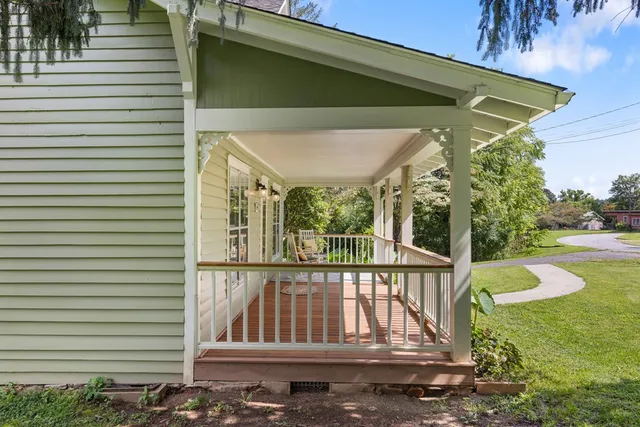 a porch with a table and chairs