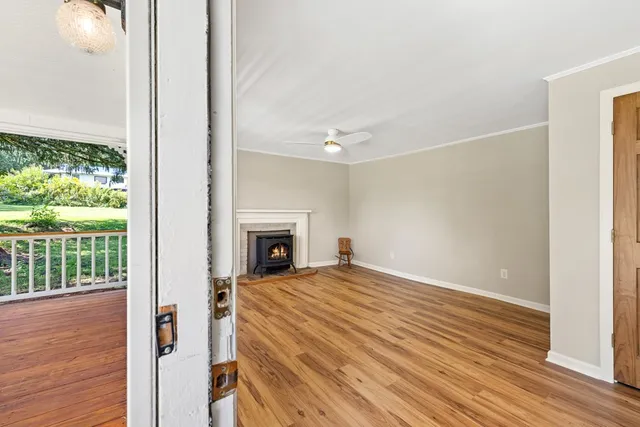 wooden floor fireplace and windows in an empty room
