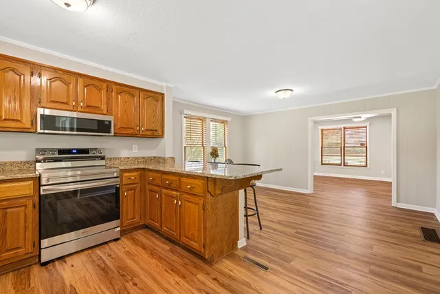 a view of a bedroom with a bed and a window