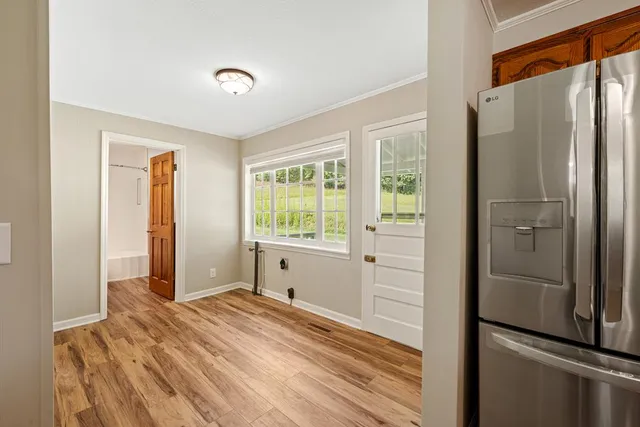 an empty room with wooden floor and closet