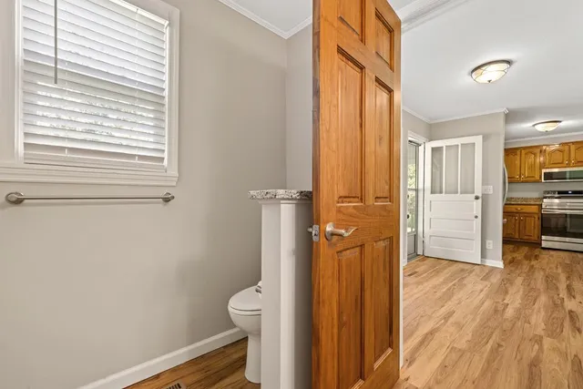an empty room with wooden floor and closet