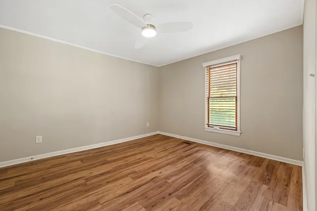 a view of a kitchen with wooden floor and electronic appliances