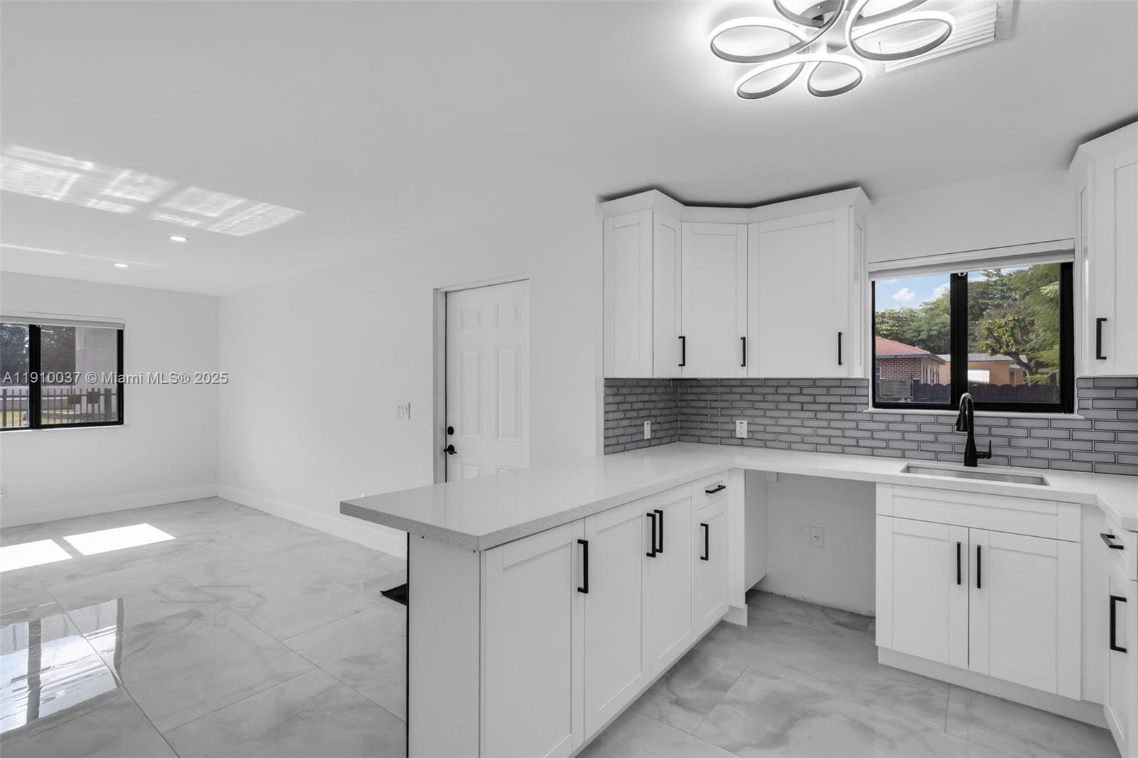 1411 Northwest 40th Street Miami, FL 33142 - Photo 11 of 52 a kitchen with white cabinets and white appliances