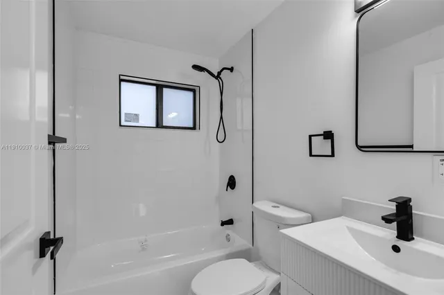 a bathroom with a toilet sink and shower