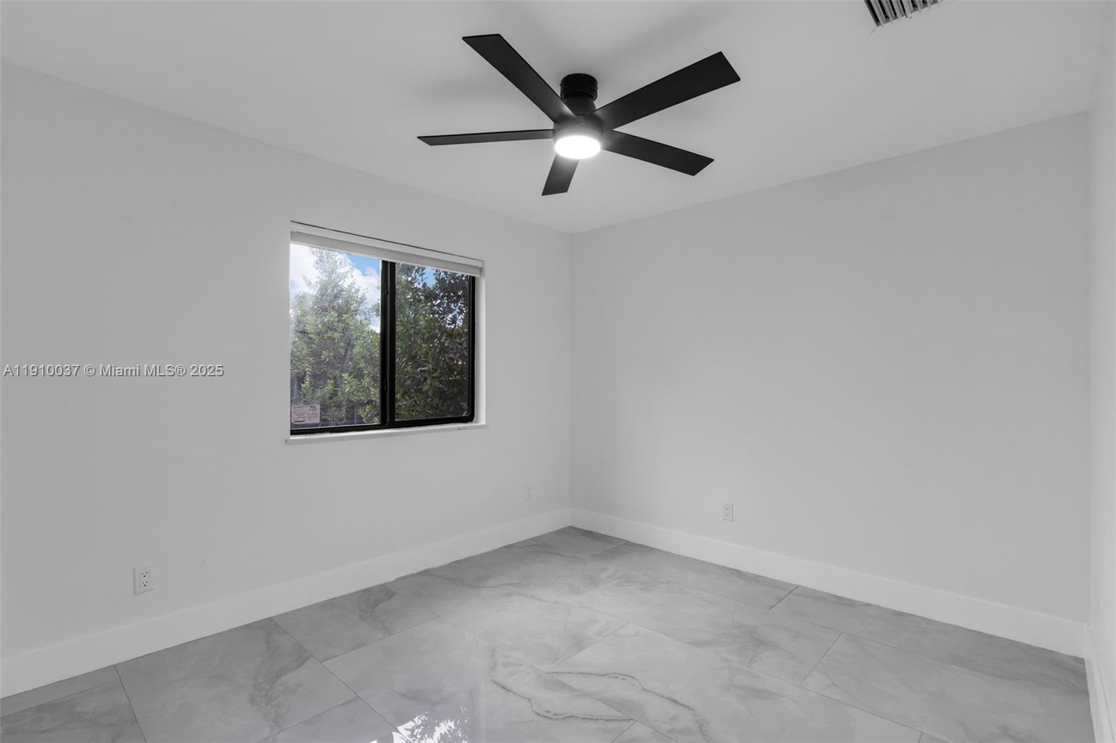 1411 Northwest 40th Street Miami, FL 33142 - Photo 16 of 52 an empty room with ceiling fan and windows