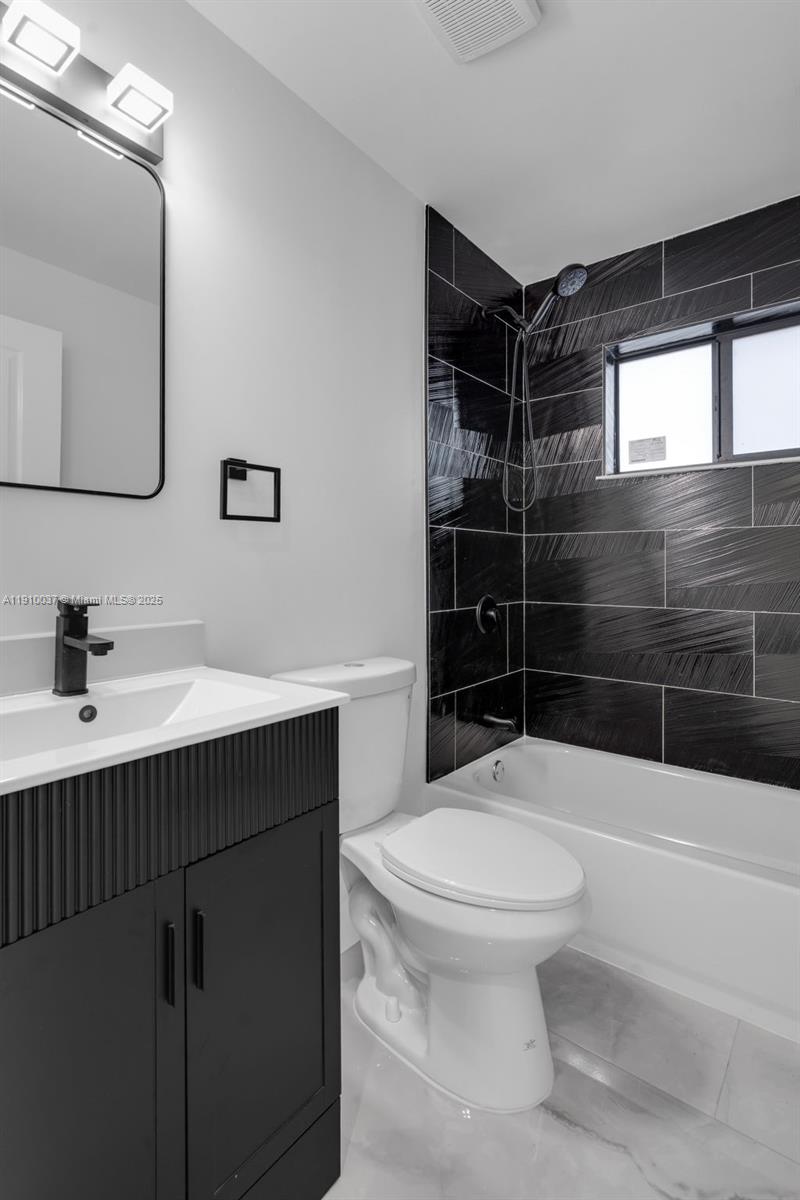1411 Northwest 40th Street Miami, FL 33142 - Photo 21 of 52 a bathroom with a sink toilet and shower