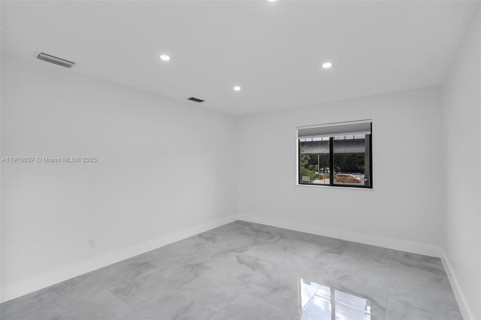 1411 Northwest 40th Street Miami, FL 33142 - Photo 25 of 52 a view of an empty room with a window