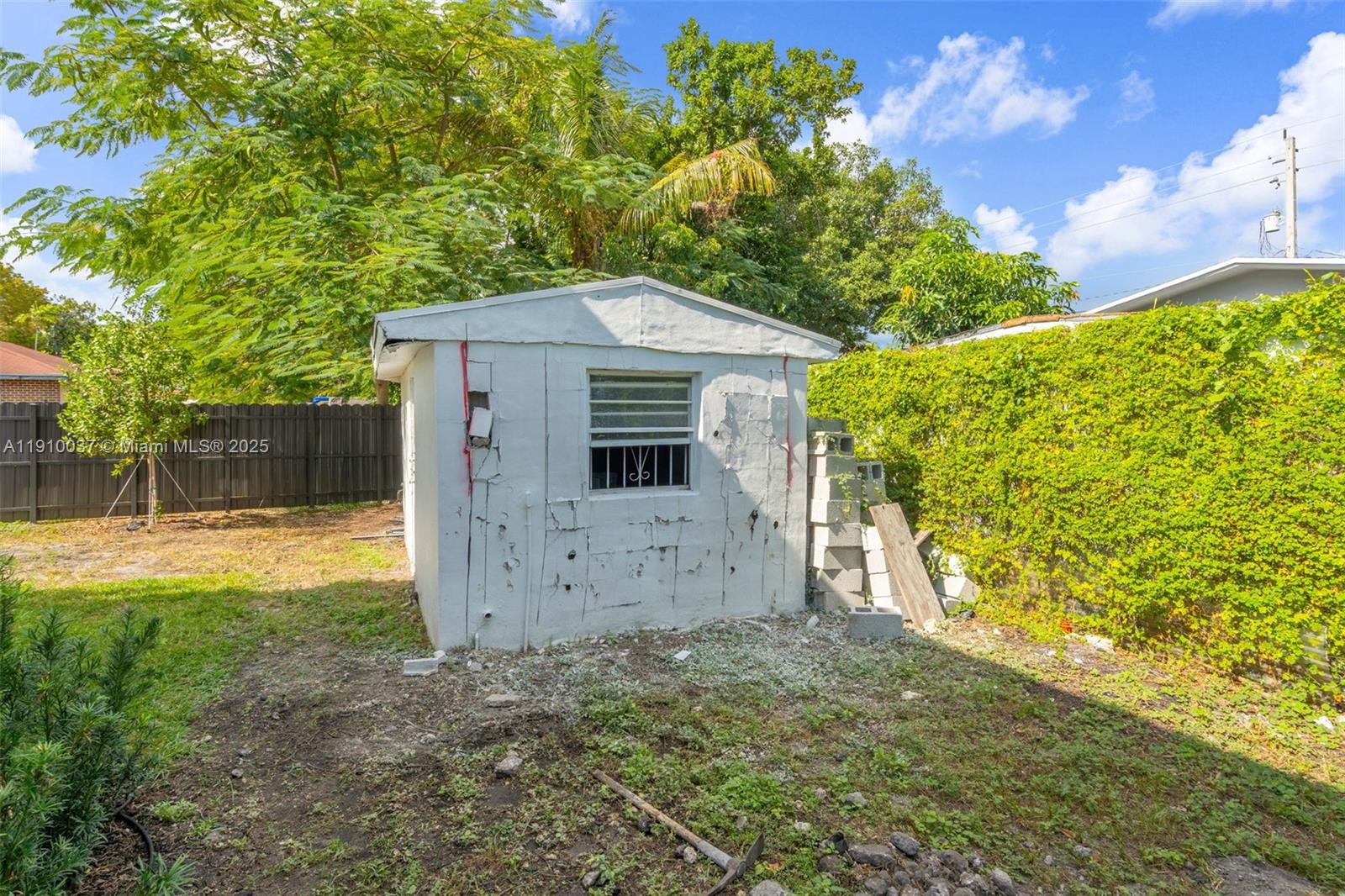 1411 Northwest 40th Street Miami, FL 33142 - Photo 41 of 52 a view of a backyard with plants and large tree